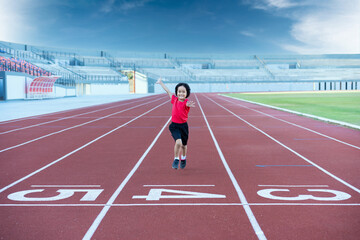 Little girl at athletics competition race. A girl running in stadium.