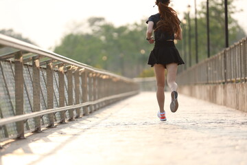 healthy young woman runner tying shoelaces with copy space, healthy lifestyle and sport concepts.