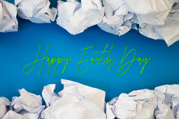 Earth Day text with Torn, Crumpled White Paper on colored background.