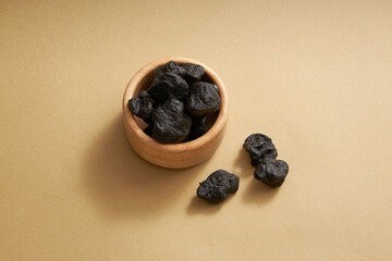 Radix rehmanniae decorated on minimalist beige background. Radix rehmanniae (Rehmannia glutinosa) appears in many folk remedies to treat diseases such as high blood pressure, bad blood, body weakness