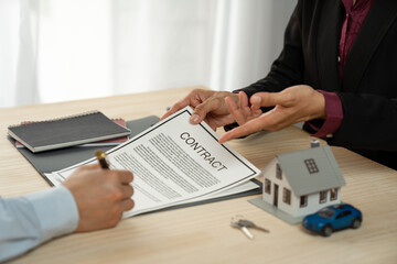 Businessman, insurance salesman explaining details in a purchase or lease contract Before the client signs the contract, the document agrees on the concept of security, investment.