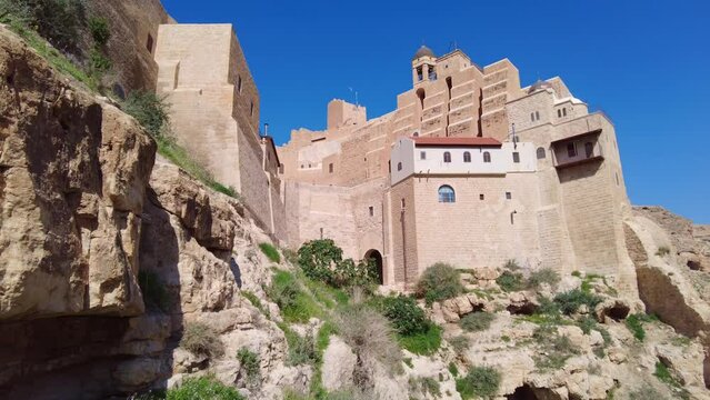 bethlehem, Palestine: The Greek Orthodox Mar Saba monastery in the Judean desert outside bethlehem in Palestine. Shot with a panoramic motion. 