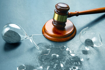 gavel of justice on the background of a broken hourglass. end of action time. expiration concept