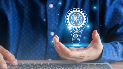 Hand of businessman hold on virtual screen light bulbs icon, the creative idea with innovation, brainstorming, the creativity of the future for business success and corporate. Business background.