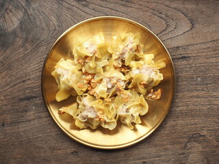 Top view Chinese steamed dumplings on golden plate