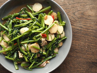 Stir fried water spinach with garlic, chili and fish balls