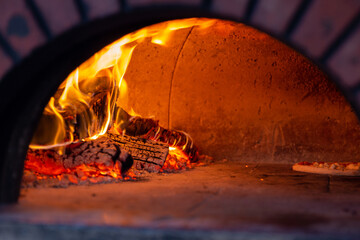 A pizza being cooked in a brick oven