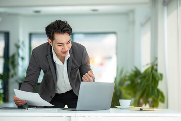 Business man using calculator for do math finance on wooden desk in office and business working background, tax, accounting, statistics and analytic research concept..