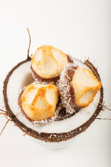 Fresh homemade delicious coconut macaroons dipped in milk chocolate and shredded coconut.