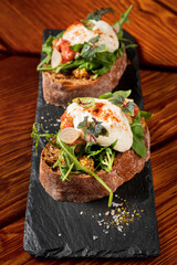Italian bruschetta with roasted tomatoes, mozzarella cheese and herbs