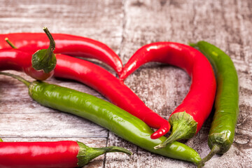Spicy Red and green pepper on wooden background in studio photo