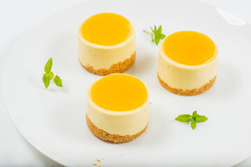 Creamy petite mango cheesecake with mango jelly and a wholewheat biscuit crumb base.