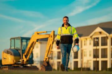 Builder with excavator for construction at the construction site. Machinery tractor with builder at...