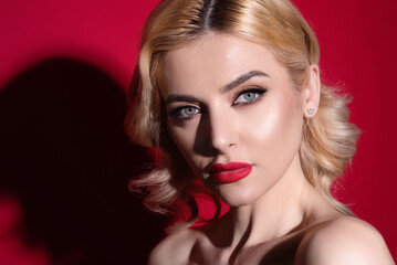 Beauty woman with fashion eyes make up, red lipstick on plump lips, blonde hair, close up face. Fashion beauty portrait of young woman with natural makeup and perfect clean skin. Sexy model.