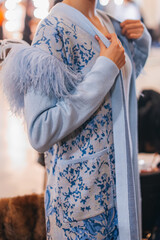 Female figure in knitting blue elegant autumn cardigan. Fashion collection details