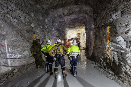 Miners underground inspecting work in progress at a mine site in Australia