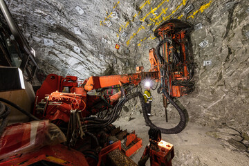 Miners underground inspecting work in progress at a mine site in Australia