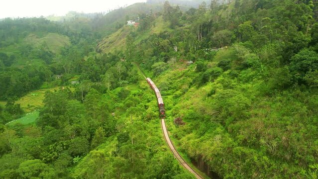 Drone Sri Lanka 4k. Train on scenic railway route Kandy to Ella, tea plantations. South Asia summer tourism.