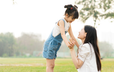image of mother and daughter playing in the park