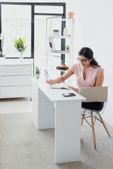 hispanic business woman working in her desk at office in Mexico Latin America	