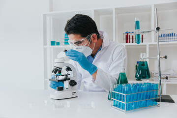 Young scientist looking through a microscope in a laboratory. Young scientist doing some research.