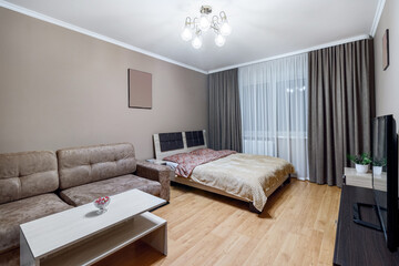 Gomtinaya in a small apartment with sofa, TV, large bed and coffee table