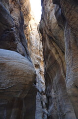 Beautiful rocks and canyons in the wild nature and the dry desert of Wadi Ghweir in Jordan on a bright sunny day