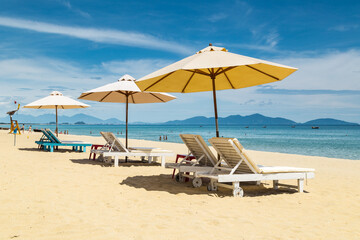 Lounge chairs and umbrellas on a white sandy beach at An Bang in Vietnam