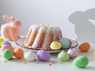 Easter cake with colorful eggs and pink bunny. Cottage cheese paskha. Easter table with traditional dessert and pink bunny. Happy Easter holidays, tasty dessert. Greating card.