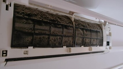 Dirty in dust and mold air conditioner filter close-up. Home air conditioner maintenance.