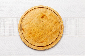Wooden cutting board on white kitchen table