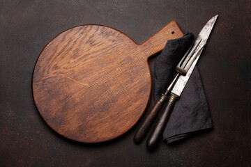 Empty cutting board, fork and knife