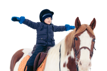 A boy child rides a horse in winter through a snowy forest, isolated on a white background