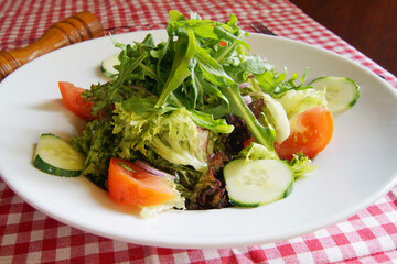 Delicious salad fresh ingredients, tomatoes and arugula.