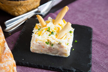The traditional Russian salad or Olivier salad is prepared with potatoes, tuna, carrots and peas.
