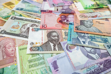 African money are scattered on the table so that it is completely covered.