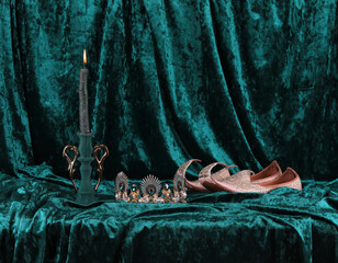 traditional arabic shoes and crown on green velvet