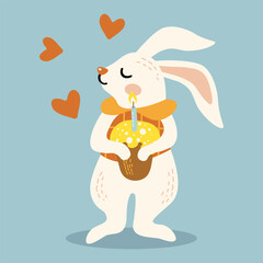 cute rabbit holds in its paws an Easter cake with candles