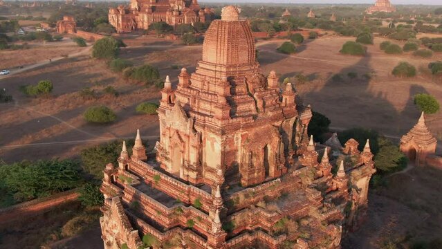 Backwards drone panning shot of the Myauk Guni and Dhammayangyi Temple in Myanmar.