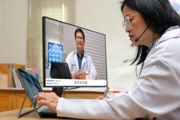 Asian woman doctor video conference discussion with doctor team about diagnosis patient symptom