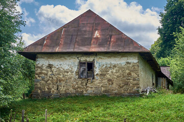 Old cracked house made of stones and clay. Abandoned house in the mountain village of Transcarpathian Ukraine
