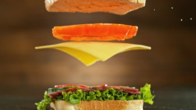 Super slow motion of stacking sandwich pieces. Camera in motion. Filmed on high speed cinema camera, 1000 fps. Placed on high speed cine bot.