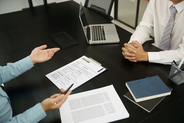 Examiner reading a resume during job interview at office Business and human resources concept.