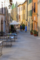 Fototapeta na wymiar Charming street with bars and wine shops in Montalcino in Tuscany. Italy