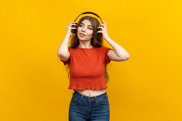 The music lover, donning a red top, is captured in a studio, surrounded by a vivid yellow color scheme. The image beautifully illustrates the fervour for music