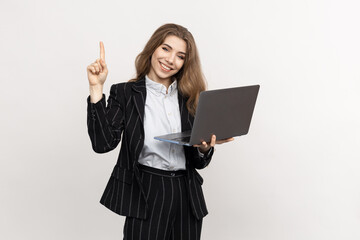 An office employee with a laptop on a white background. The woman points her finger to the side