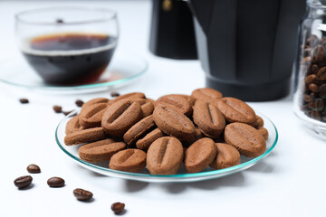 Concept of tasty snack for hot drink - cookies in the shape of coffee seeds