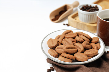 Concept of tasty snack for hot drink - cookies in the shape of coffee seeds