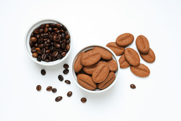 Concept of tasty snack for hot drink - cookies in the shape of coffee seeds