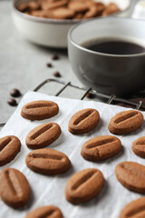 Concept of tasty snack for hot drink - cookies in the shape of coffee seeds